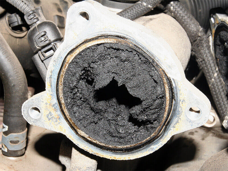 Wet stacking deposits in generator exhaust path showing carbon fouling associated with prolonged low-load operation